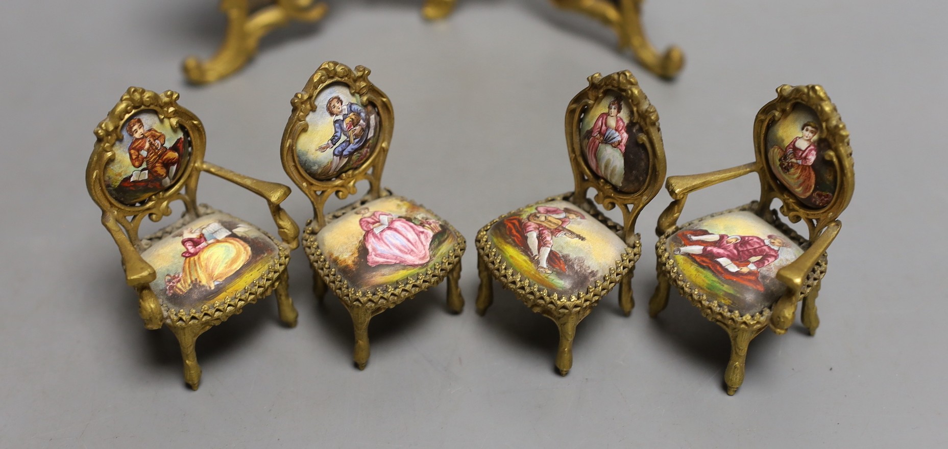 A suite of Viennese enamelled miniature furniture: 3 fold screen, table, salon sofa, a pair of armchairs and 2 dining chairs